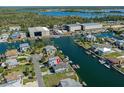 Aerial view of the property on a waterfront canal with a metal roof and private boat dock at 4046 Casa Ct, Hernando Beach, FL 34607