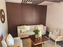 Bright living room with beige couches, a wooden coffee table, and a decorative brown wall at 4601 N 37Th St, Tampa, FL 33610