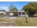 Charming home with a carport, fenced yard, and mailbox, offering a welcoming curb appeal at 4743 Foothill Dr, Holiday, FL 34690