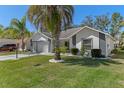 Charming single-story home boasts a well-manicured lawn and beautiful landscaping with decorative concrete driveway at 7305 Sugarbush, Spring Hill, FL 34606
