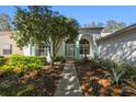 Charming one-story home featuring manicured landscaping, a walkway, and decorative exterior accents at 11231 Sun Tree Rd, Hudson, FL 34667