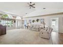 Spacious living room features a vaulted ceiling, neutral carpet, and an abundance of natural light at 11231 Sun Tree Rd, Hudson, FL 34667