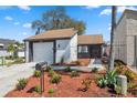 Inviting home with a well-maintained front yard featuring colorful plants and tidy mulch at 12236 Saddle Strap, Hudson, FL 34667