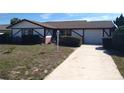 Charming single-story home featuring a well-maintained front yard and a single car garage at 13610 Claudia Dr, Hudson, FL 34667