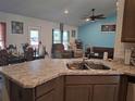 Open kitchen featuring granite countertops and a stainless steel sink at 18336 Macek Rd, Weeki Wachee, FL 34614