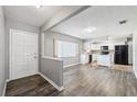 Open concept kitchen with white cabinetry and black appliances with views to the living room at 2608 W Fletcher Ave, Tampa, FL 33618