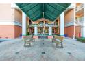 Covered entryway with tiled floor, benches and a sculpture at the Seaview Place at Gulf Landings community at 4516 Seagull Dr # 408, New Port Richey, FL 34652