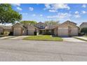 View of the street showcasing well-maintained two-story homes, manicured lawns, and attached garages at 6518 Remus Dr, New Port Richey, FL 34653