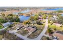 Aerial view of a home near a lake with a spacious yard and mature trees at 6822 Eastbrook Dr, Spring Hill, FL 34606