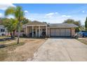 Charming one-story home featuring a well-maintained lawn and a long driveway at 7514 Bergamot Dr, Port Richey, FL 34668