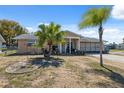 Charming one-story home featuring a well-maintained lawn and beautiful landscaping at 7514 Bergamot Dr, Port Richey, FL 34668