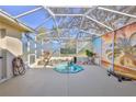 Enclosed patio with a small decorative pool, lush greenery, and unique wall art at 9131 Rhett Ln, Weeki Wachee, FL 34613