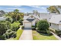 Charming single-story home with well-manicured lawn, lush shrubbery and a two-car garage at 9144 Bassett Ln, New Port Richey, FL 34655