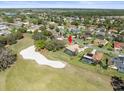 Aerial view of a home with golf course frontage and a screened pool at 9630 Southern Belle Dr, Weeki Wachee, FL 34613