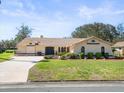 Attractive single story home featuring a well-manicured lawn and a spacious driveway at 9630 Southern Belle Dr, Weeki Wachee, FL 34613