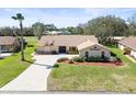 Inviting front exterior with mature landscaping and a concrete driveway at 9630 Southern Belle Dr, Weeki Wachee, FL 34613
