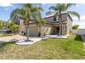 Beautiful two-story home with a well-manicured lawn and driveway at 11895 Crestridge Loop, New Port Richey, FL 34655