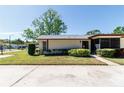 Well-kept single-story home showcasing a manicured lawn and a welcoming entrance at 1223 Queen Anne Dr # B, Palm Harbor, FL 34684