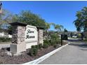 Stone sign for Rose Haven community entrance amidst landscaping and palm trees at 12403 Coralbean Ct, New Port Richey, FL 34654