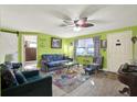 Bright living room featuring stylish furniture, a ceiling fan, and ample natural light at 13906 Barnard Ave, Hudson, FL 34667