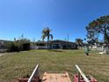 Expansive backyard with a white picket fence and view of the house at 13930 Berkowitz Ave, Hudson, FL 34667