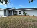 This charming home boasts a well-maintained lawn, fresh exterior paint, and a welcoming covered entryway at 1713 Walden Ct, Englewood, FL 34224