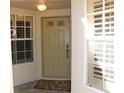 A welcoming front entrance with sidelight windows and a neutral-colored door, perfect for guests at 2568 W Brook Ln, Clearwater, FL 33761