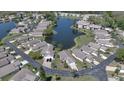 Aerial view of a residential neighborhood with a pond and well-maintained landscaping at 4429 Whitton Way, New Port Richey, FL 34653
