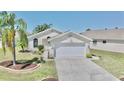 Charming single-story home with well-manicured lawn and attached two-car garage at 4429 Whitton Way, New Port Richey, FL 34653