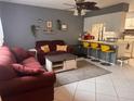 Cozy living area with a kitchen view, features neutral tones, and tile flooring at 5249 Courtland Rd, Spring Hill, FL 34608