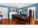 Dining room with fireplace, wood table, chandelier, and hardwood floors at 6244 Warren Ave, New Port Richey, FL 34653