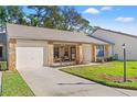 Inviting home exterior with a one-car garage, covered entry, and a well-kept lawn at 6652 Brambleleaf Dr, Spring Hill, FL 34606