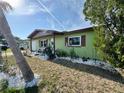 Single story home surrounded by decorative landscaping including a palm tree at 8053 Hixton Dr, Port Richey, FL 34668