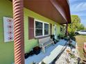 Cozy front porch featuring neutral bench seating, colorful plants, and decorative stone landscaping at 8053 Hixton Dr, Port Richey, FL 34668