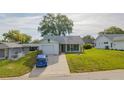 Street view of a single-story home featuring a driveway and well-kept front lawn at 8121 Casuarina Dr, Port Richey, FL 34668