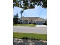 Well-maintained single-story home with a two-car garage and a beautifully landscaped front yard in a quiet neighborhood at 8630 Ne Coral Creek Loop, Hudson, FL 34667