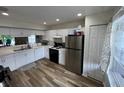 Bright kitchen with stainless steel appliances and wood-look flooring at 9485 Hamlin Blvd # 8, Seminole, FL 33776