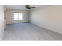 Spacious living area with a window, allowing natural light, ready for personalization and comfortable living at 11001 Peppertree Ln, Port Richey, FL 34668