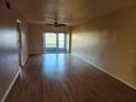 Bright living room featuring wood flooring and sliding glass doors to the back patio at 11130 Carriage Hill Dr # 1, Port Richey, FL 34668