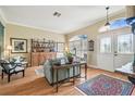 Bright living room featuring beautiful wood floors, a large window and ornate details at 11339 Alden Ct, Hudson, FL 34667