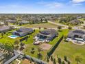 Expansive aerial view showcases three homes each with swimming pools and spacious landscaped yards at 1155 Buckhurst Dr, Spring Hill, FL 34609