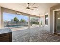 Covered outdoor patio features stone flooring with backyard pool view and an open pergola area at 1155 Buckhurst Dr, Spring Hill, FL 34609