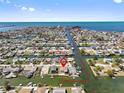 Aerial view of waterfront neighborhood featuring canal access to the Gulf, single Gathering homes, and sea breezes at 13820 Plumosa Ave, Hudson, FL 34667