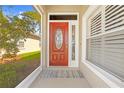 Elegant front entrance with a decorative glass door, providing a warm welcome and plenty of natural light at 14471 Sterling Run, Spring Hill, FL 34609