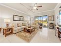 Bright living room featuring neutral décor, comfortable seating, and large sliding doors leading to the outdoors at 14471 Sterling Run, Spring Hill, FL 34609