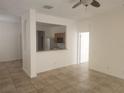 Bright living room showcasing tile floors and an open floor plan to the kitchen at 14656 Wake Robin Dr, Brooksville, FL 34604
