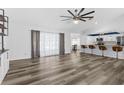 Bright living room with modern wood-look flooring and open layout to the kitchen with a breakfast bar and lots of light at 15193 Copeland Way, Brooksville, FL 34604