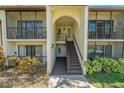 A close up shot of the building entrance with stairway to the upper units at 1737 Pine Ridge W Way # B-1, Palm Harbor, FL 34684