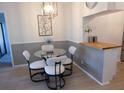 Dining area with seating, modern lighting, and decorative wall art at 19505 Quesada Ave # Bb-103, Port Charlotte, FL 33948