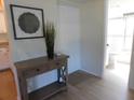 Entryway with wood flooring and decor with a view of the bathroom at 19505 Quesada Ave # Bb-103, Port Charlotte, FL 33948